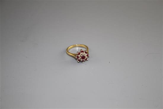 A modern 18ct gold, ruby and diamond set flower head cluster ring, size I, gross weight 3.7 grams.